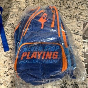 Brand new Pickleball backpack. blue and orange  balls, clothes, and paddles,